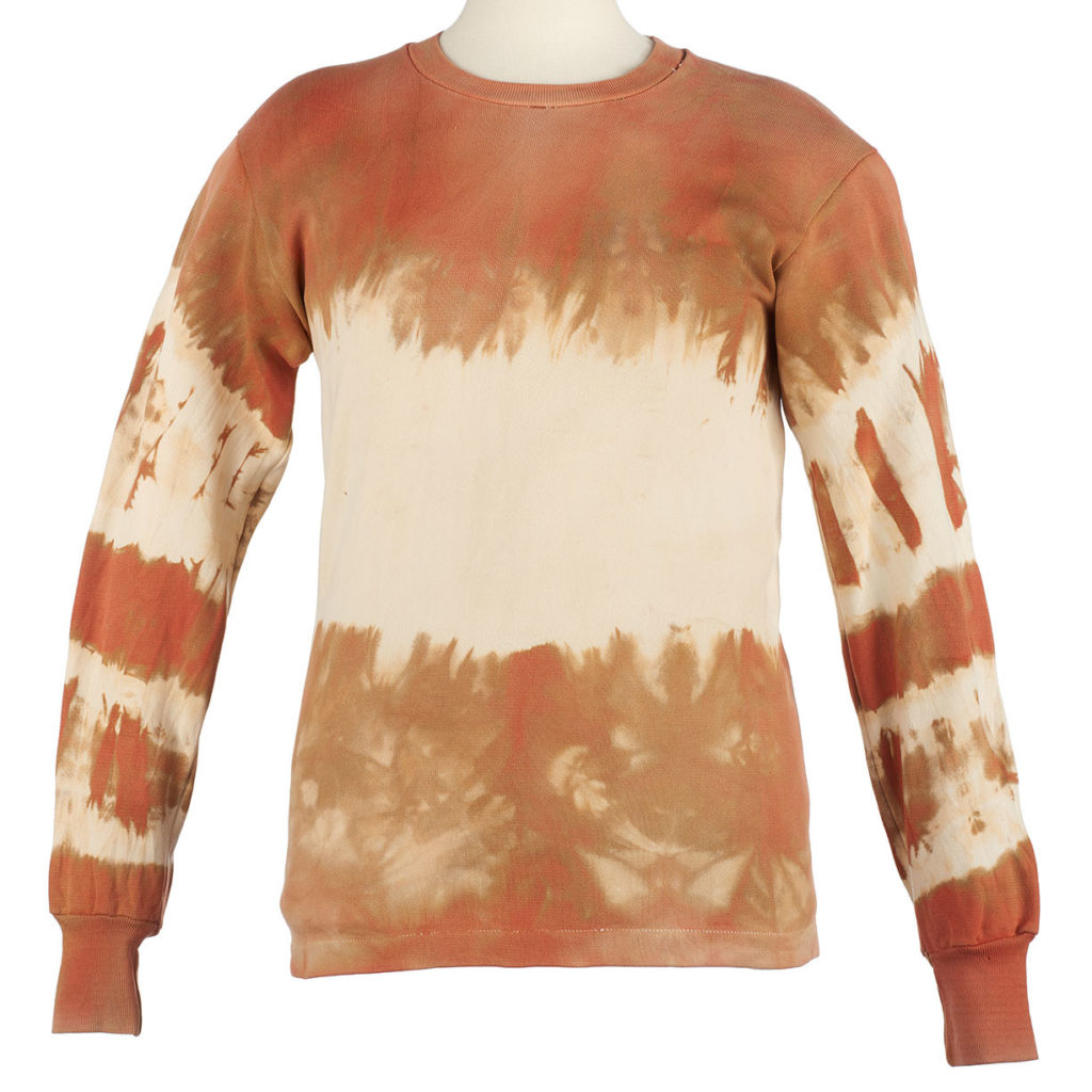a sweatshirt that has been tie-dyed with ochre.