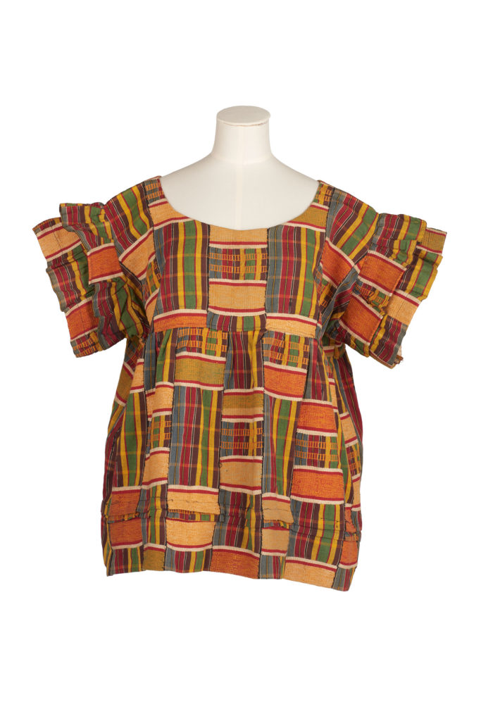 woman's bloused tailored from strips of red, orange, green, yellow and blue kente cloth