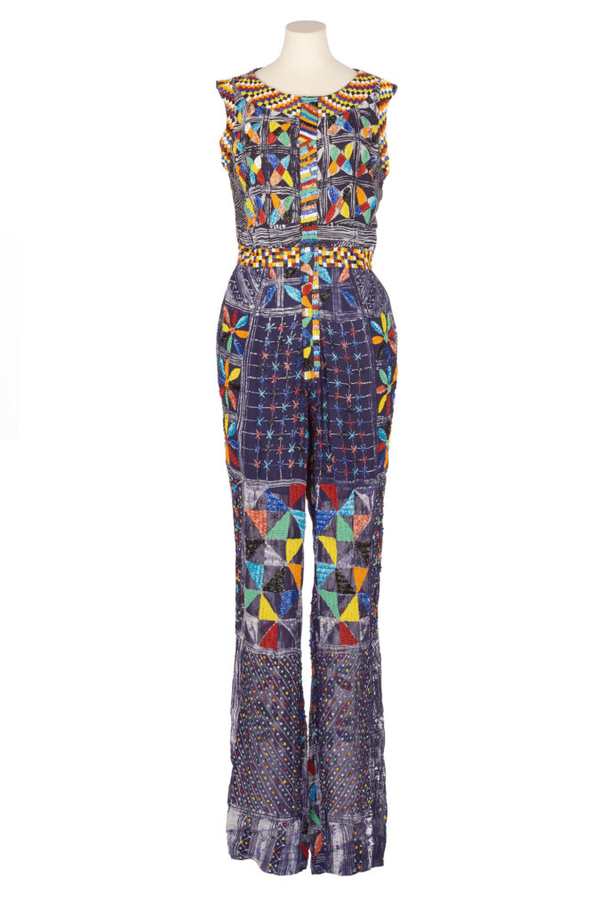Woman's indigo adire jumpsuit with brightly coloured beaded embellishments