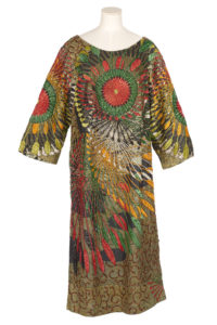 Woman's shift dress in brown wax print with red, yellow and green beaded embellishments.
