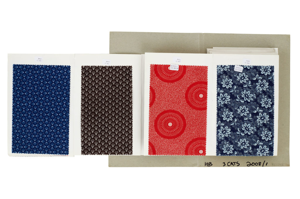 Four swatches of shweshwe fabric in a sample book