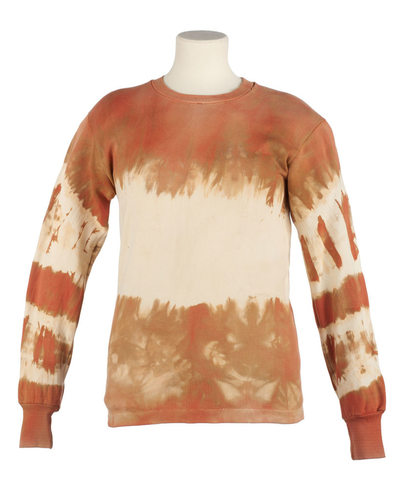 a white sweatshirt tie-dyed with red ochre