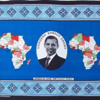 Blue kanga cloth featuring a portrait of Barack Obama and two maps of Africa.
