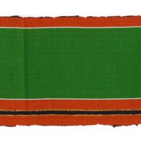 detail of handwoven green and orange striped aso-oke cloth