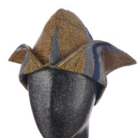 a man's blue and gold aso-oke cap with two triangular flaps on a mannequin head