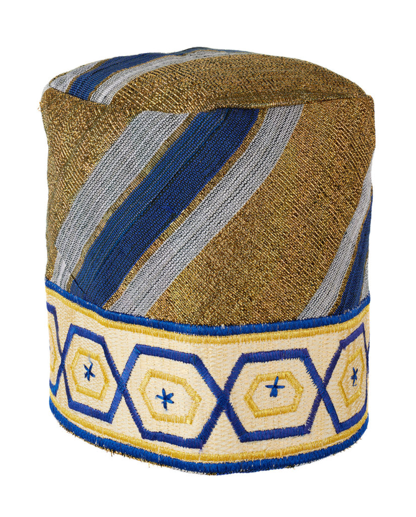 a blue and gold aso-oke cloth cap
