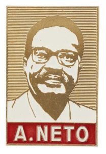 Rectangular shaped metal badge featuring a portrait of Agostinho Neto in white enamel.