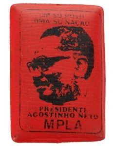 Rectangular red pin badge made of padded plastic featuring Agostinho Neto