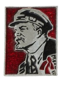Rectangular shaped metal badge featuring a portrait of Lenin in red and black enamel.