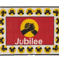 red, white, yellow and black cloth with two clasped hands and the word jubilee
