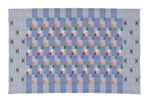 pale blue kente fabric with blocks of small pink, orange, green, white and red squares