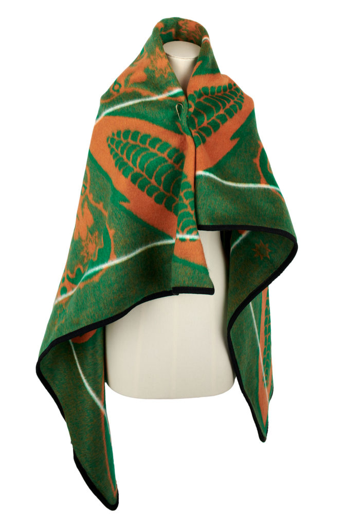 green and yellow basotho blanket styled on a mannequin, worn on the shoulders
