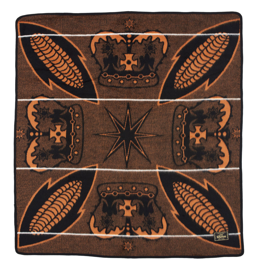 Square brown, black and yellow basotho blanket with a design of corncobs and crowns