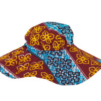 Woman's hat with a wide brim made of wax print fabric, blue and maroon with yellow flower motif.