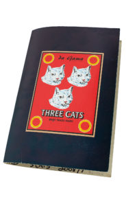 cardboard sample book with three white cat faces on a red background with a black border