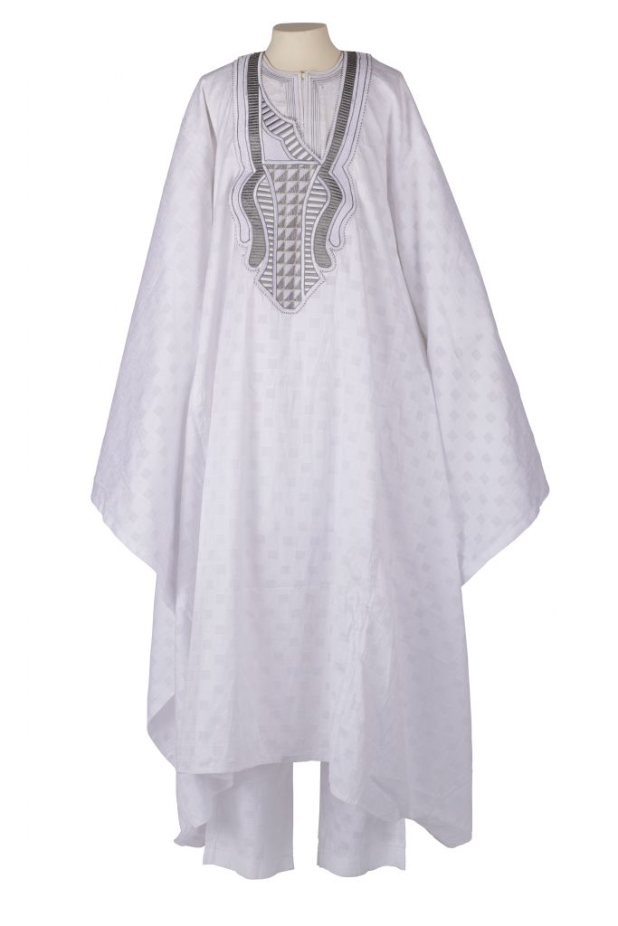 Man's robe and trousers in a white fabric woven with geometric designs and a silver metallic trim.
