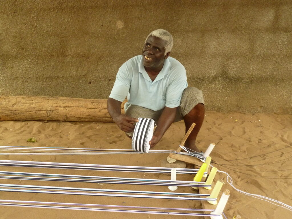 1.	Joseph Wordu demonstrating how to lay the warp for a striped fabric, 