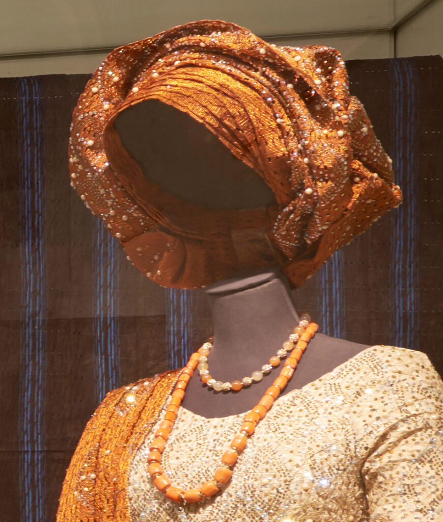 orange gele headwrap styled on mannequin