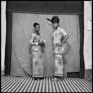 Studio portrait of two young women wearing wax print wrappers